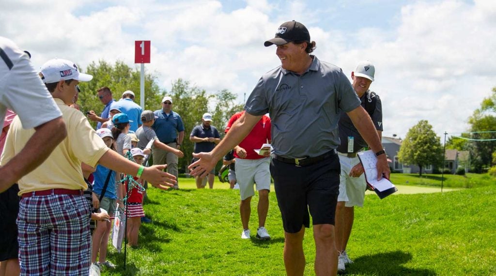 Phil Mickelson greets fans during a practice round at the 2019 3M Open.