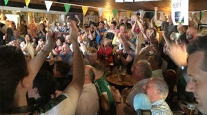 Those packed into the Esker Hills clubhouse cheer as Shane Lowry clinches his Open Championship victory on Sunday.