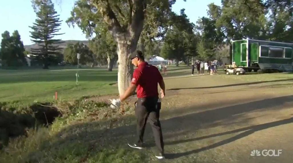 Bryson DeChambeau was dismayed to find his ball in a penalty area behind the grandstand on No. 18.