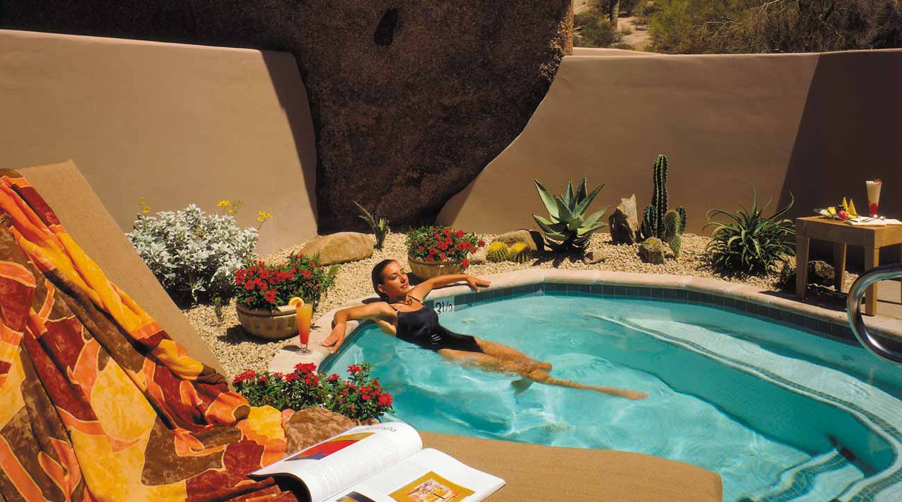 A guest relaxes in the sun at Four Seasons Resort Scottsdale at Troon North.