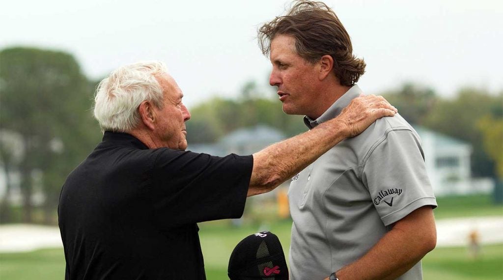 Arnold Palmer talks with Phil Mickelson during the 2010 Arnold Palmer Invitational at the Bay Hill.