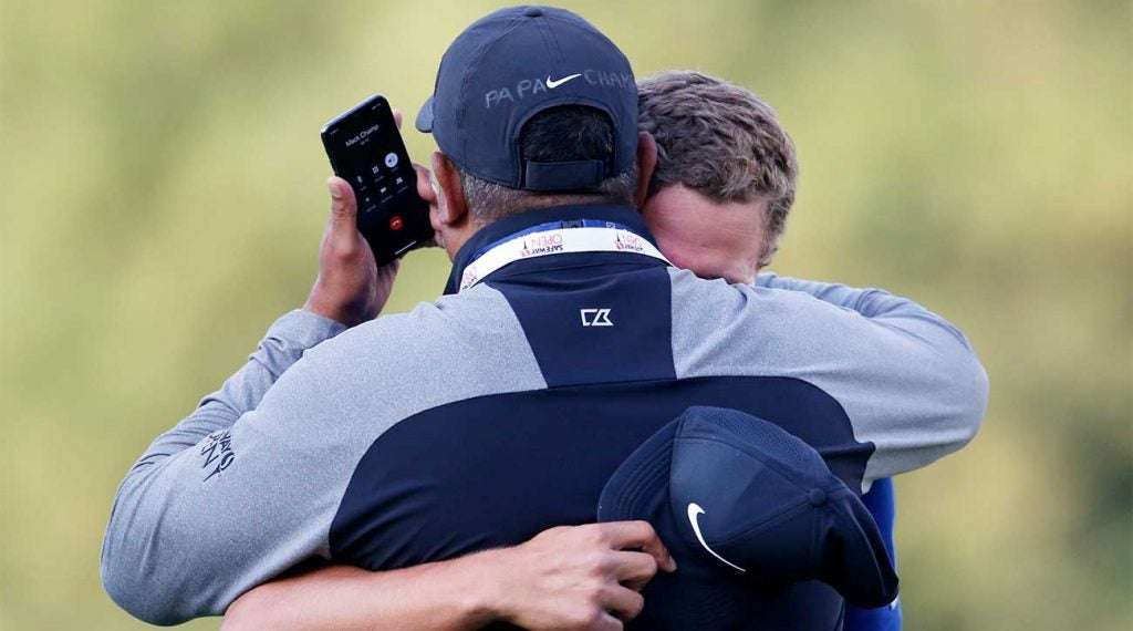 Cameron Champ hugs his dad while his grandfather is on the phone after Champ's Safeway Open title.