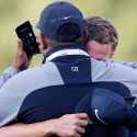 Cameron Champ hugs his dad while his grandfather is on the phone after Champ's Safeway Open title.