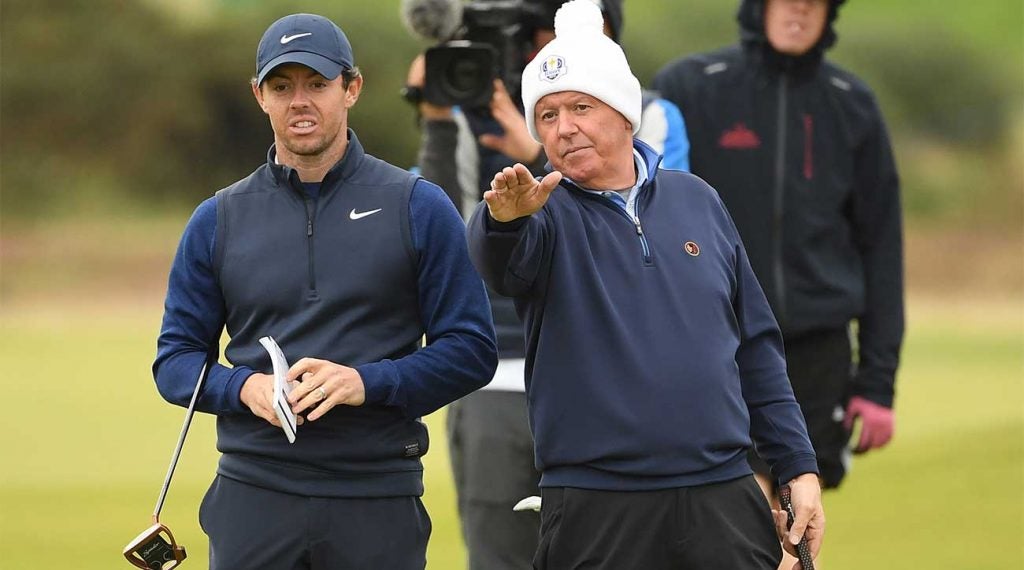 Rory McIlroy and his dad, Gerry, look over a shot at the Dunhill Links Championship in Scotland.