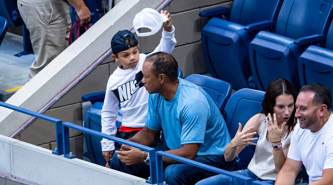 Charlie Woods swipes the hat off his dad Tiger's head.