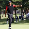 Tiger Woods raises his putter after winning the Zozo Championship on Monday in Japan.