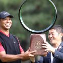 Tiger Woods finally accepts the Zozo Championship trophy after a lengthy ceremony.