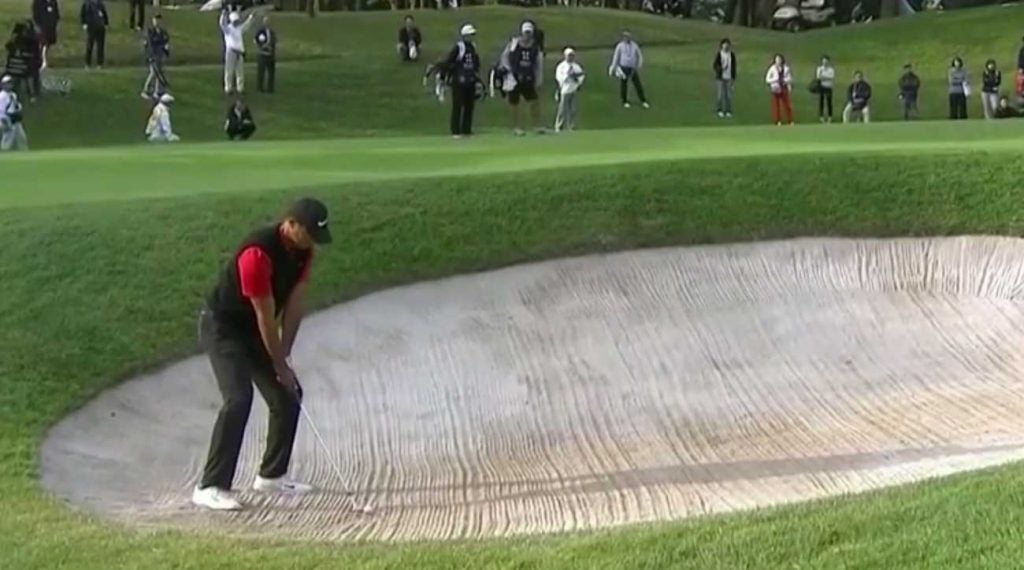 Tiger Woods blasts out of the bunker on Monday at the Zozo Championship.