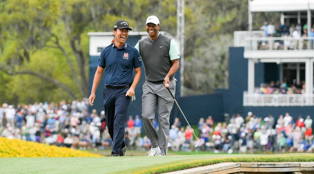 Tiger Woods and Kevin Na walk off the 17th green at TPC Sawgrass during the 2019 Players.