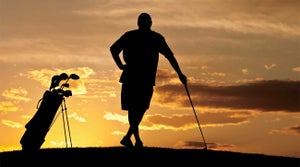 A golfer in the sunset