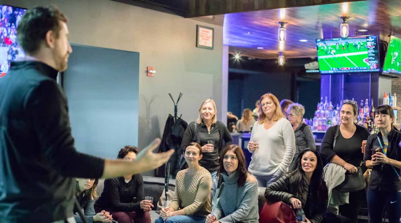 Attendees at a Chicago Fore the Ladies event listen to a guest instructor.