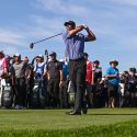 Tiger Woods tees off in front of his usually large group of fans.