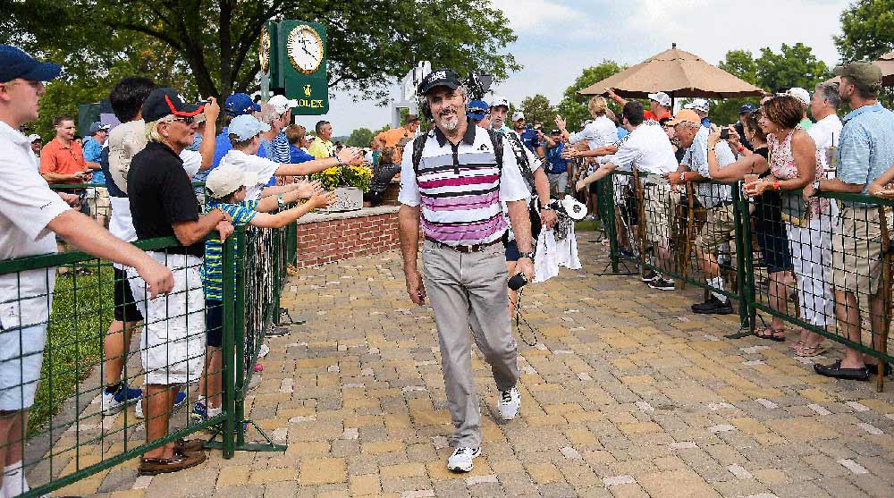David Feherty takes a walk to the next tee during a broadcast.