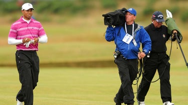 An ESPN camerman follows Tiger Woods at the 2010 Open Championship at St. Andrews