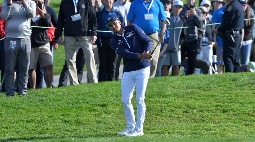 Rickie Fowler hits a chip shot at the Farmers Insurance Open.