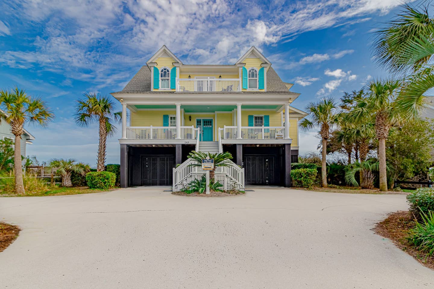 Yellow beach house with blue shutters in Myrtle Beach, South Carolina.