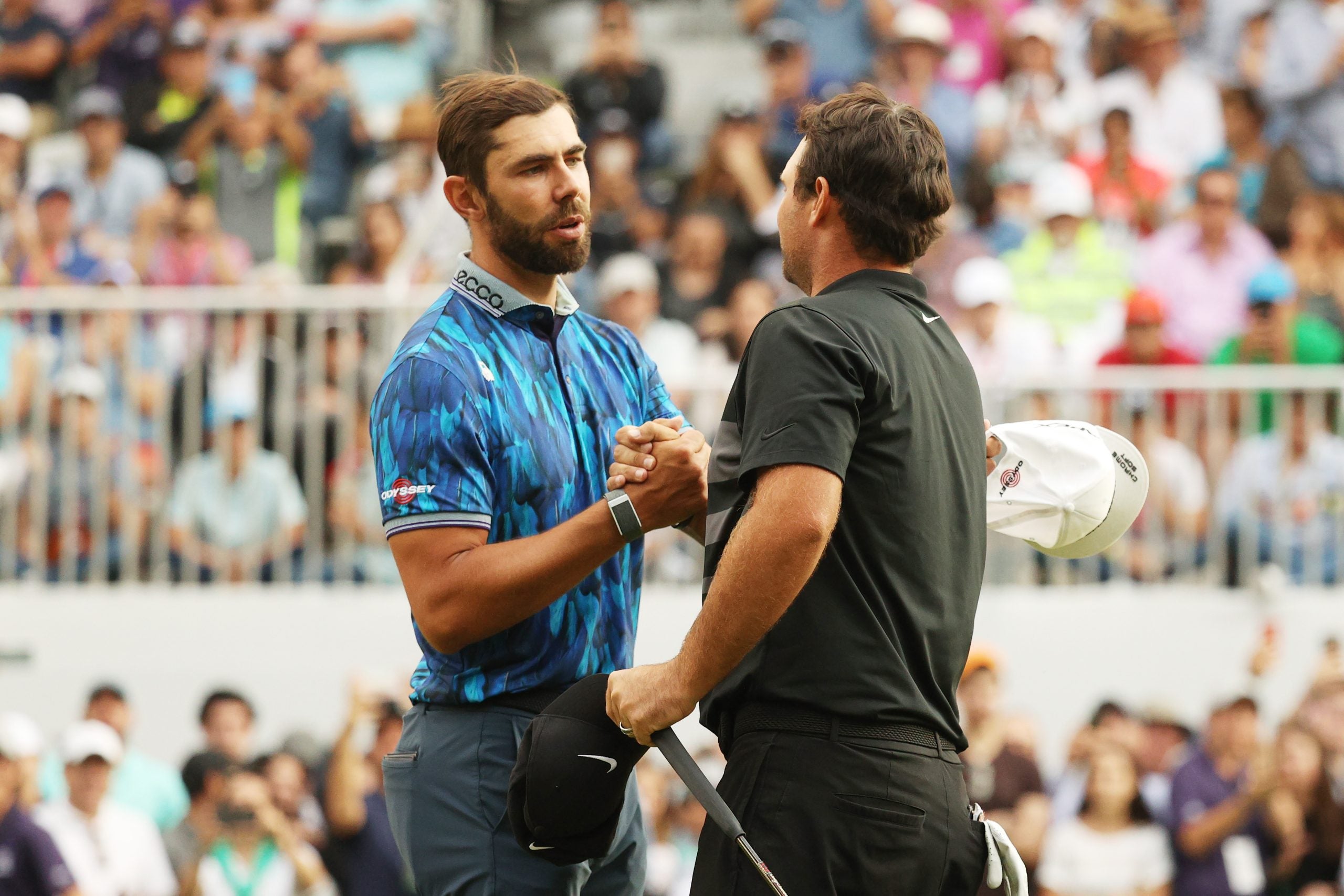 Erik van Rooyen congratulates Patrick Reed after Reed's victory.