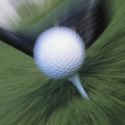 A clubhead hitting a golf ball at high speed