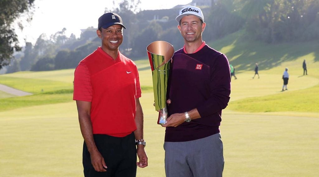 Tiger Woods presents the Genesis Invitational trophy to Adam Scott.