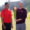 Tiger Woods presents the Genesis Invitational trophy to Adam Scott.