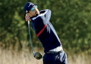 Michael Phelps plays a shot during the celebrity challenge match ahead of the 2018 Ryder Cup.