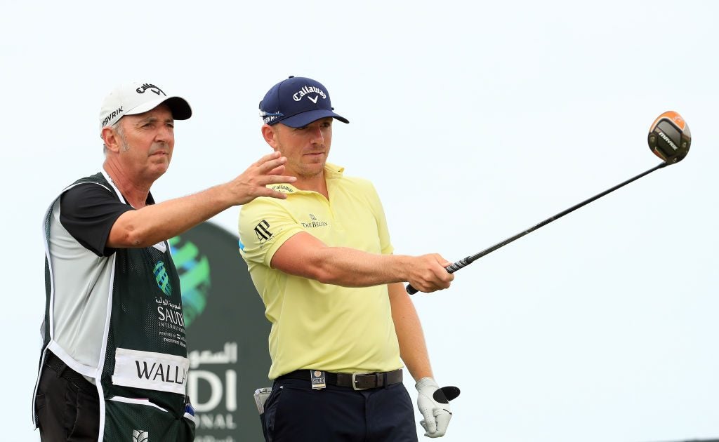 Matt Wallace and his caddie talk over a shot at the Saudi International on Jan. 31, 2020.