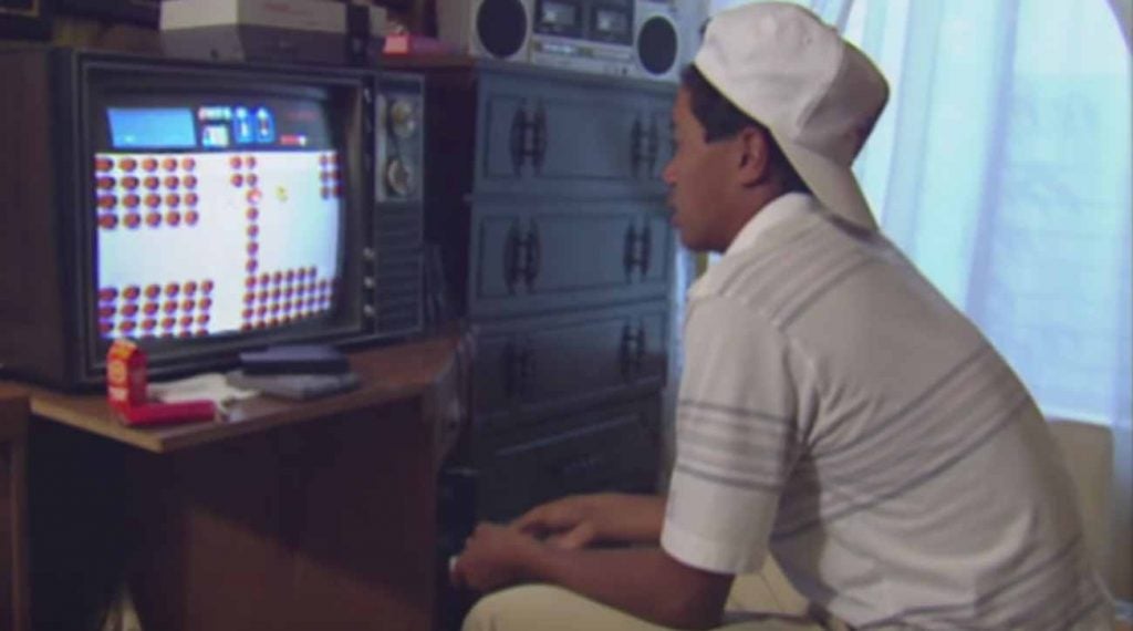 Tiger Woods, rocking a Lakers hat, playing video games in his house.