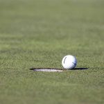 Golf ball approaches hole
