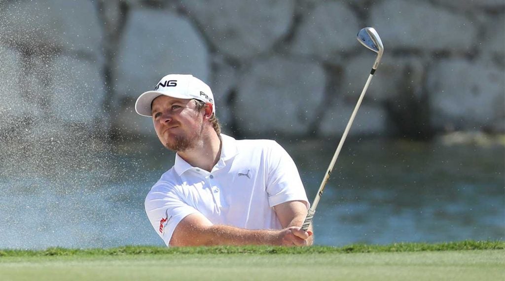Eddie Pepperell hits out of a bunker during the first round of the Qatar Masters on Thursday.