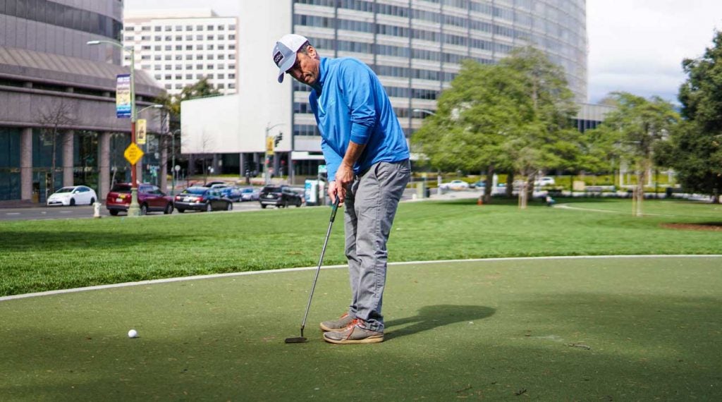 Golfer practices putting at Snow Park in Oakland, Calif.