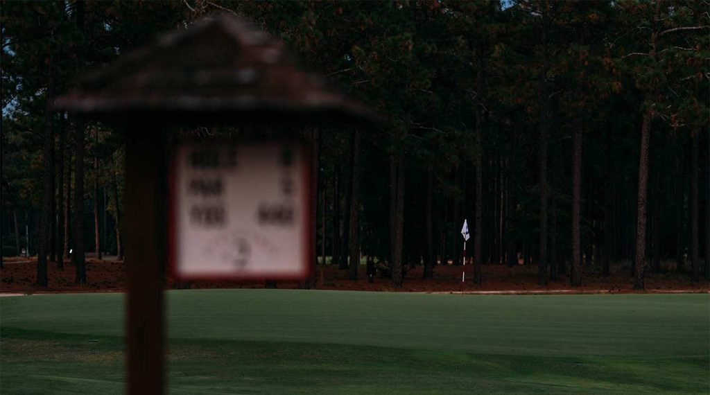 A tee box sign and green at Pinehurst No. 2.