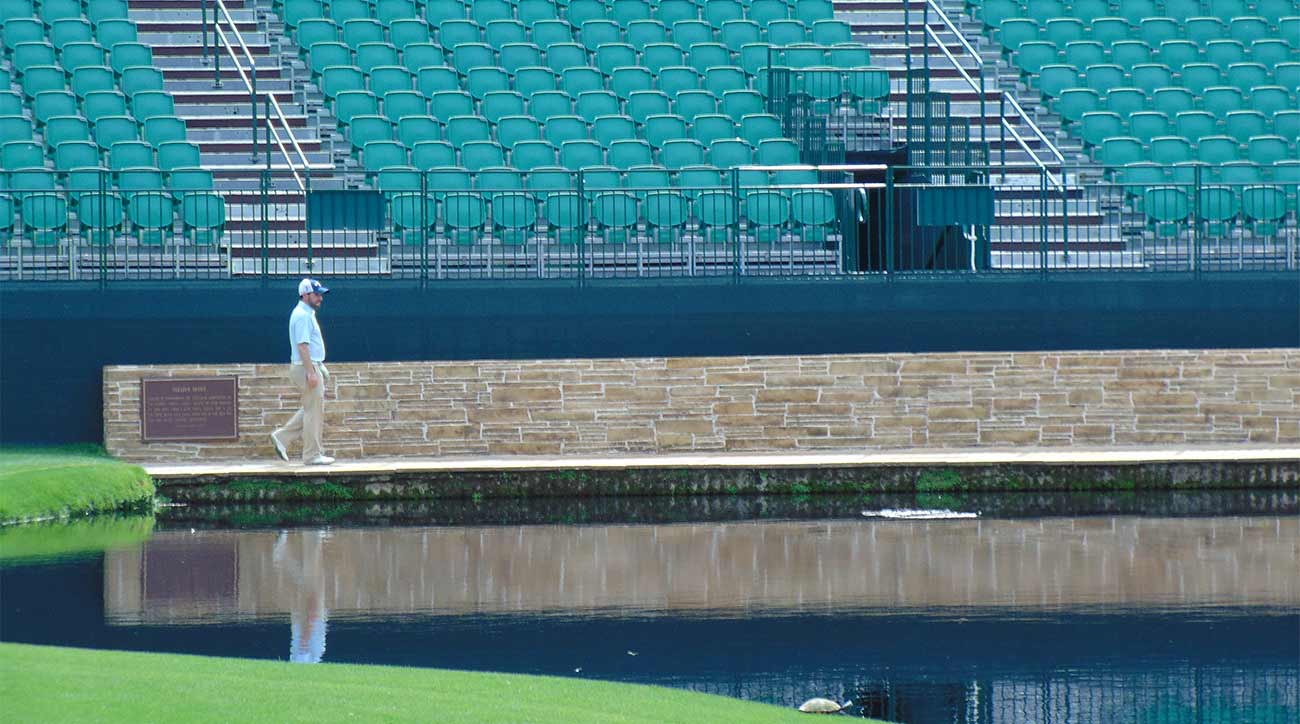 Ryan Asselta walks across the Sarazen Bridge to the 15th green.