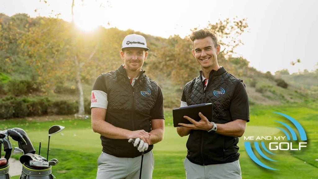 Two golf instructors pose for photo