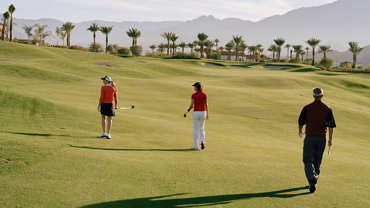 Golfers social distancing on the golf course.