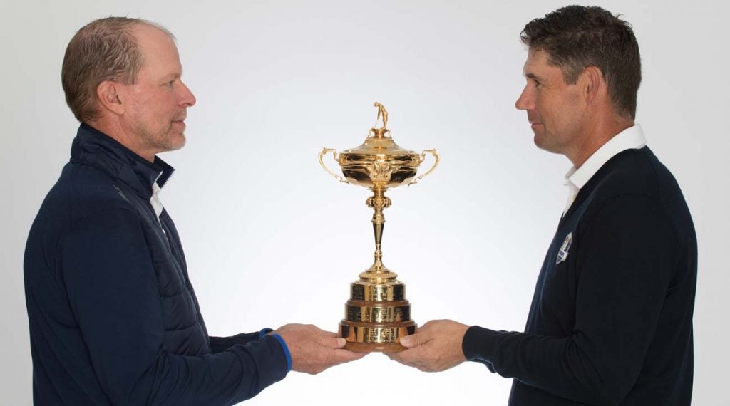 U.S. captain Steve Stricker (left) and European captain Padraig Harrington hold the Ryder Cup.