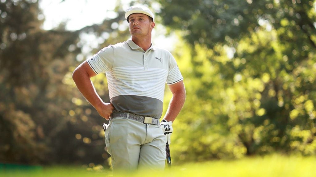 Bryson DeChambeau stands in a fairway.