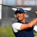 Tiger Woods hits a tee shot earlier this year.