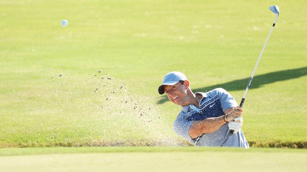 Rory McIlroy hits out of a bunker on the 16th hole at Seminole Golf Club.