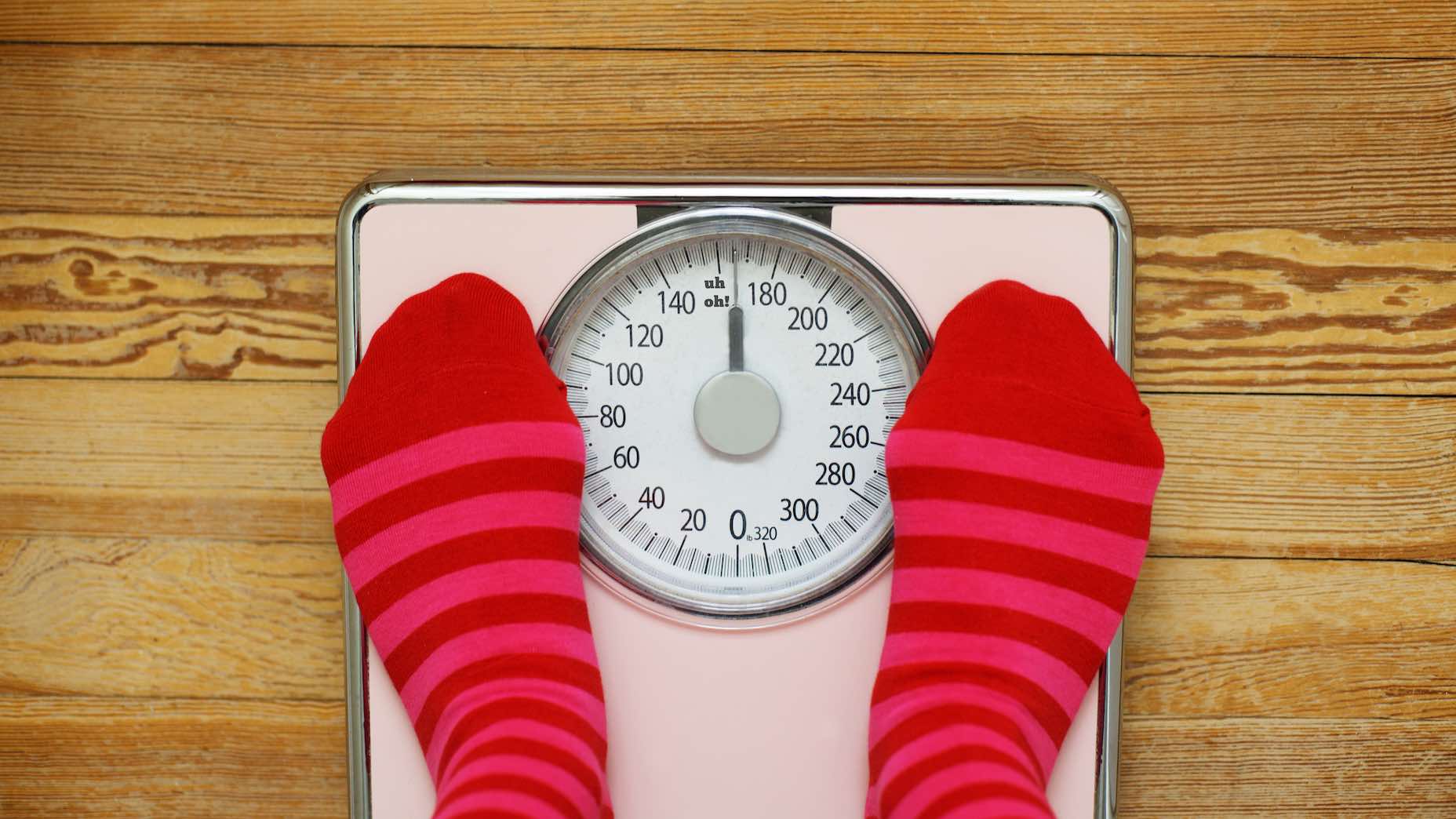 Pink striped socks standing on pink scale