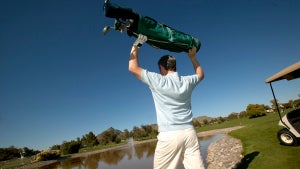 Man throwing golf cart into lake