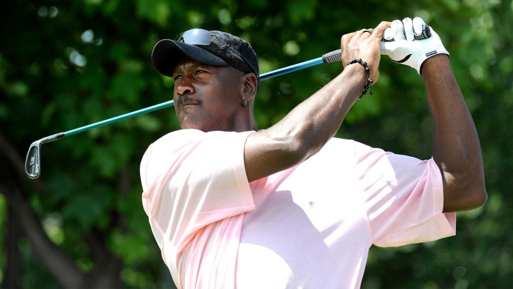 Michael Jordan swings a golf club.