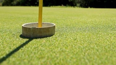 A raised cup on a golf course.