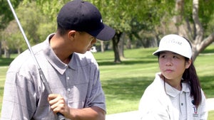 Tiger Woods walked up and down the El Dorado range, talking to junior golfers.