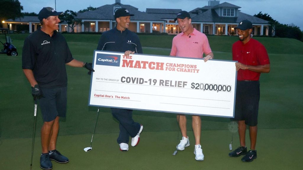 Phil Mickelson, Tom Brady, Peyton Manning, Tiger Woods hold large check