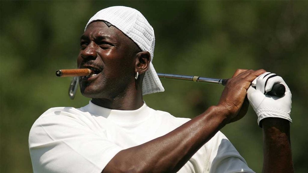 Michael Jordan takes a swing on the golf course.