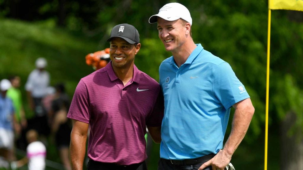 Tiger Woods and Peyton Manning on golf green