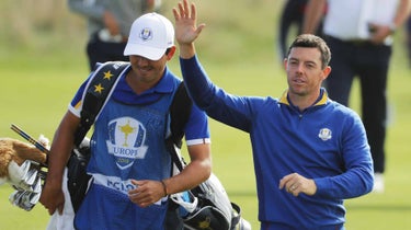 Rory McIlroy and caddie walk at Ryder Cup