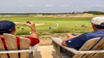 golfers look out over sand valley