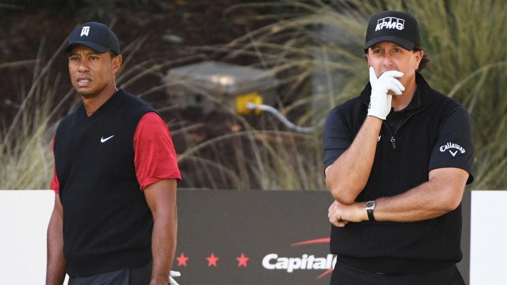 Tiger Woods and Phil Mickelson watch golf shot