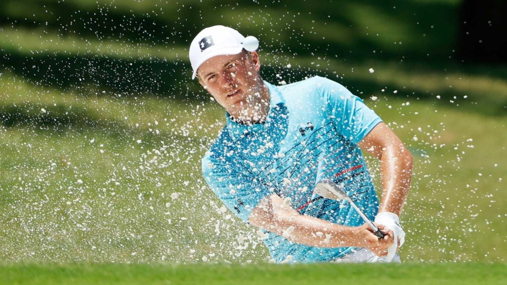 Jordan Spieth hits from a bunker on the first hole at Colonial Country Club.